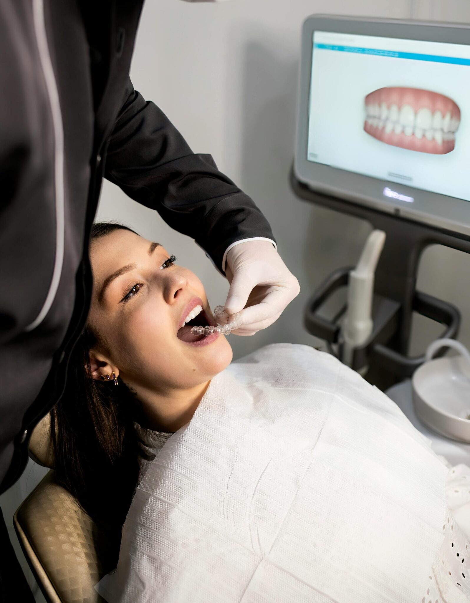 A dentist performs a patient's dental checkup using modern equipment in a clinic.